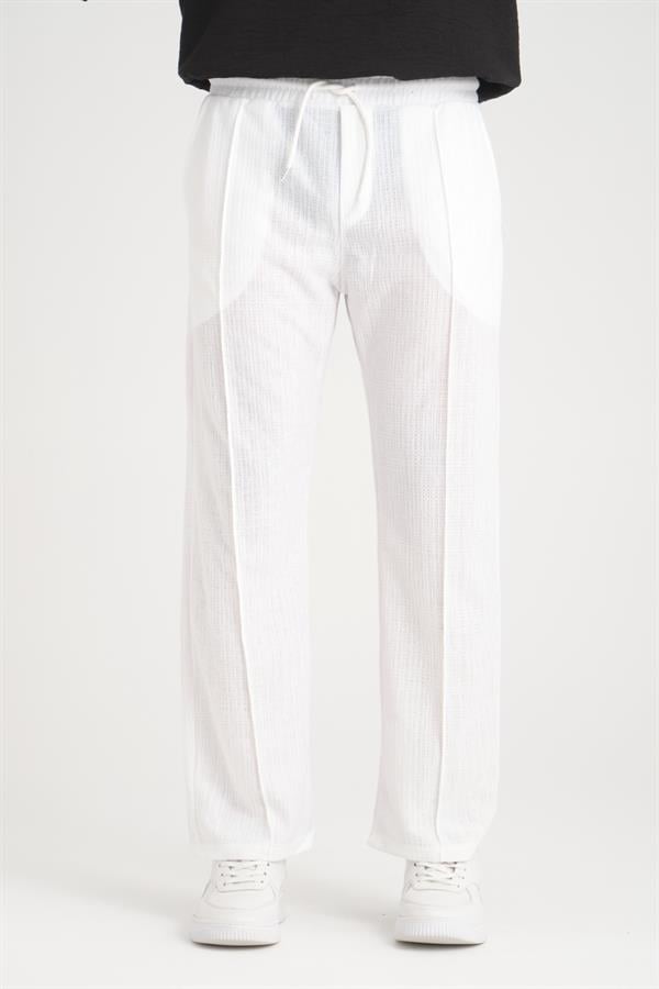 <tc>Pantalon en coton baggy à taille élastique avec un design uni et une coupe confortable.</tc>