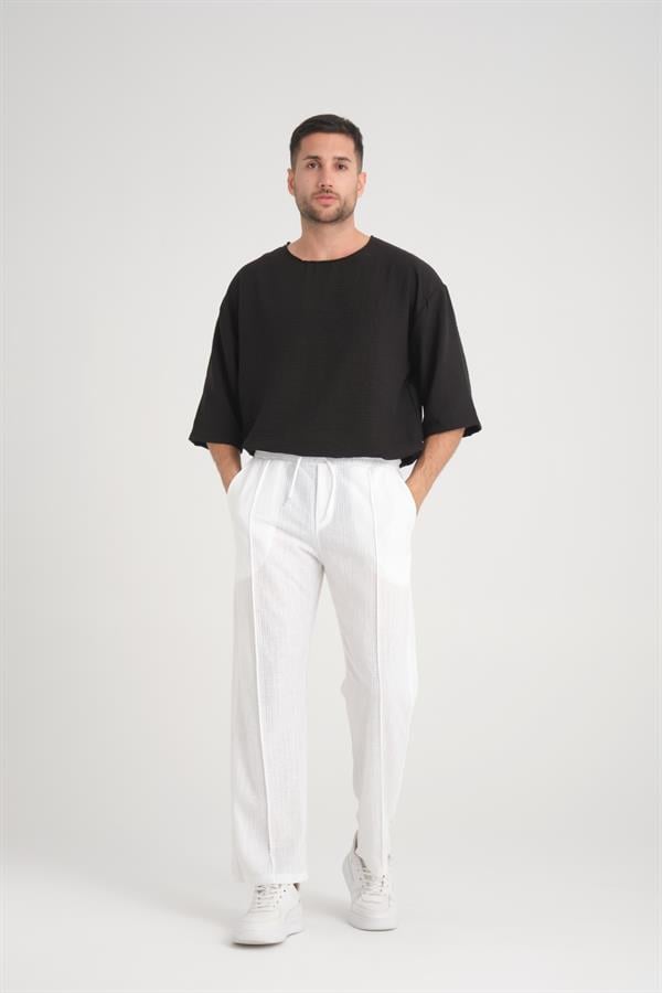 <tc>Pantalon en coton baggy à taille élastique avec un design uni et une coupe confortable.</tc>