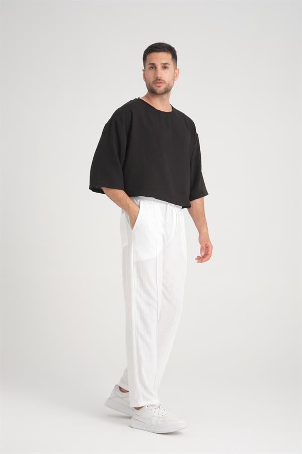 <tc>Pantalon en coton baggy à taille élastique avec un design uni et une coupe confortable.</tc>