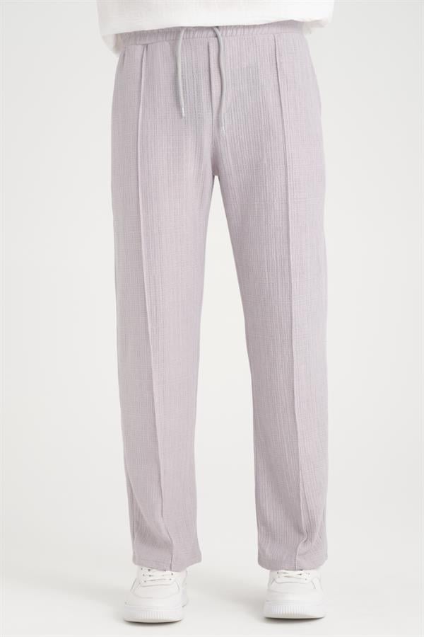 <tc>Pantalon baggy à taille élastique avec un design uni et une coupe confortable.</tc>